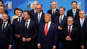 President Donald Trump poses during a group photo of NATO heads of state and government at the NATO summit in The Hague