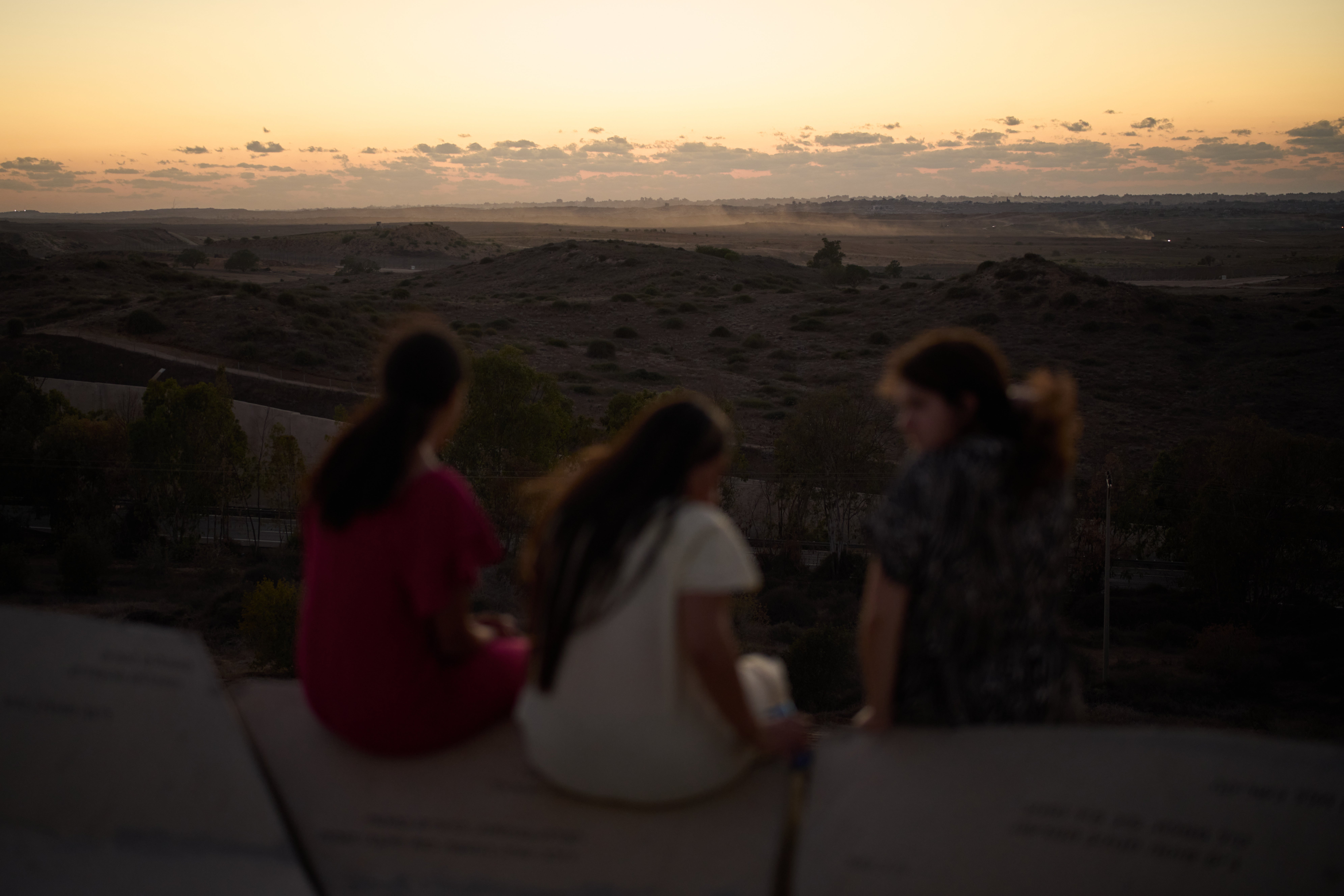 People observe buildings that were destroyed during the Israeli ground and air operations in the northern of Gaza Strip as they visit a sightseeing area in Sderot, southern Israel, Tuesday, Oct. 14, 2025. 