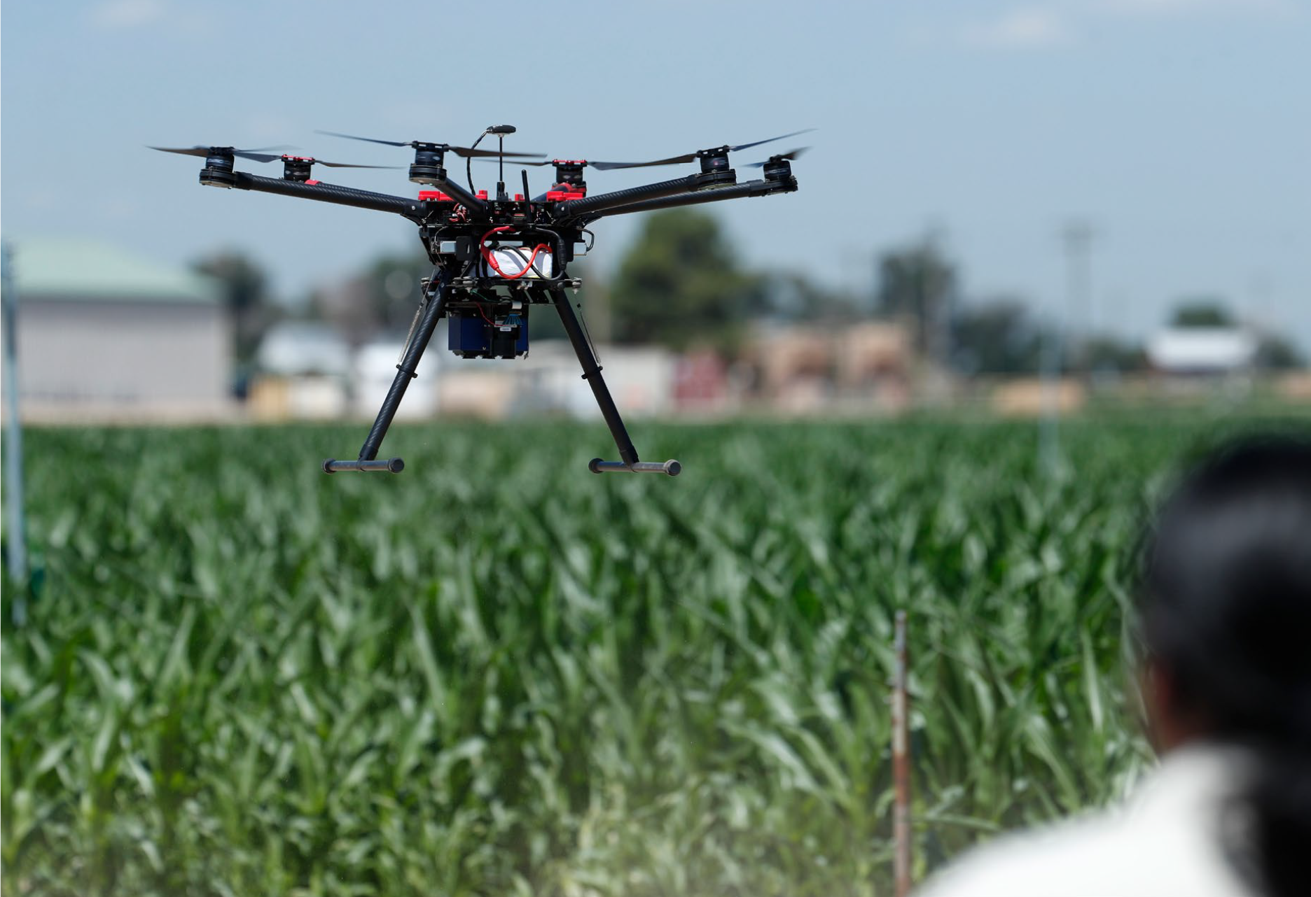 A drone flies over a crop