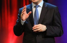 Zhang Weiwei speaking on a stage