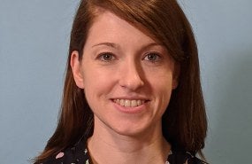 Abigail Conrad is pictured from the shoulders up smiling into the camera.
