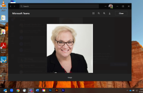 Sally Rockey is pictured from the shoulders up wearing a black blazer, smiling into the camera.