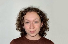 Headshot of Lily Fillwalk wearing a red sweater and looking into the camera.