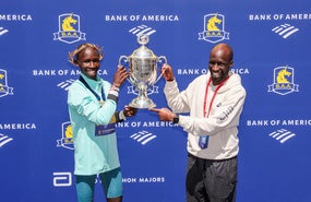 Wesley Korir holding up a trophy at the 2025 Boston Marathon.