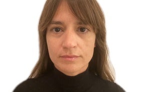 Woman with bangs in black turtleneck