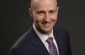 Headshot of Michael A. Hunzeker.