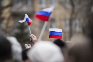 People wave the Russian flag.