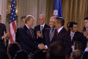Carter and Omar Torrijos shake hands moments after the signing of the Torrijos-Carter Treaties.