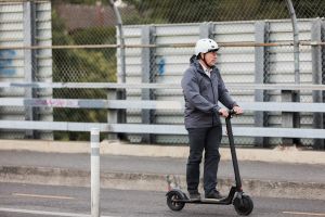 Man riding an e-scooter. 