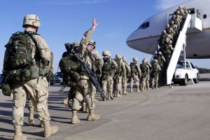 Members of the 82nd Airborne board a plane to deploy to Kuwait
