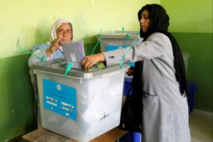 An Afghan woman casts her vote during parliamentary elections at a polling station in Kabul, Afghanistan