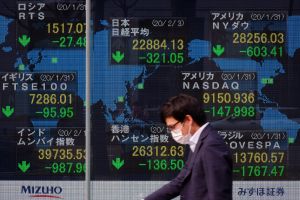 A monitor shows the Nikkei stock average rate and others falling in Osaka, Japan on February 3, 2020.
