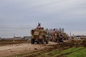 A convoy of U.S military vehicles moves in the village of Khirbet Amo, near Qamishli, Syria