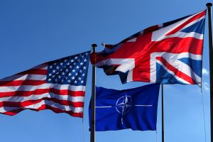 US, NATO and Britain flags fly at the Alliance headquarters in Brussels.