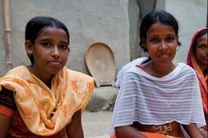 Two young girls sitting down to eat