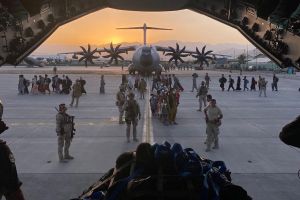 Soldiers in Afghanistan viewed from inside plane.