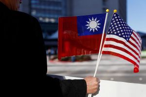 A demonstrator holds US and Taiwan flags