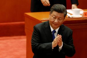 Xi Jinping clapping his hands while speaking