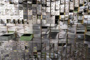 A wall of safety deposit boxes in a bank