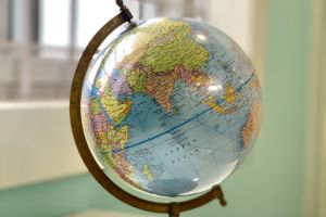 A globe sitting on a table, showing the continent of Asia