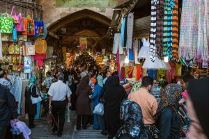 A crowd of people at the entrance to a market in Tehran