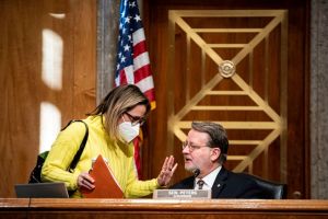 Senator Kyrsten Sinema, a Democrat from Arizona, speaks with Senator Gary Peters, a Democrat from Michigan 