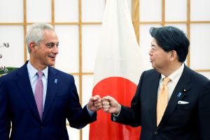 Japan's Foreign Minister Yoshimasa Hayashi (R) fist bumps with new US ambassador to Japan Rahm Emanuel 