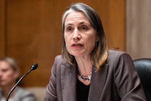 Fiona Hill is seen speaking into a mic at a hearing