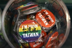 Close up of bin of rainbow buttons that say "I'm From Taiwan."