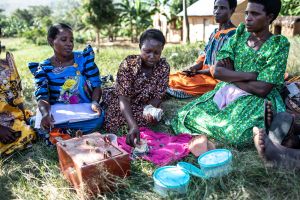 Gorreti Ndagire (center) counts money during a Savings and Internal Lending Communities (SILC) group meeting in Katoosi village, Ddwaniro subcounty, Rakai district, Uganda.
