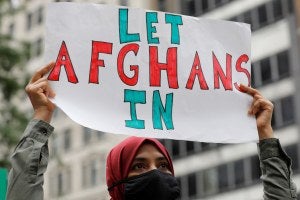 A demonstrator holds up a sign that says Let Afghans In during a rally in New York City 