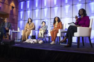 Four speakers and a moderator discuss food insecurity on stage at the 2022 White House Conference on Hunger, Nutrition, and Health.