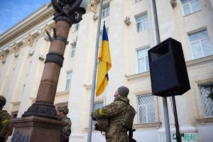 A soldier hoists the State Flag of Ukraine in deoccupied Kherson