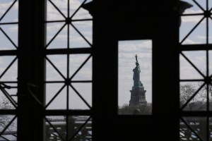 the Statue of Liberty seen through a window from Ellis Island