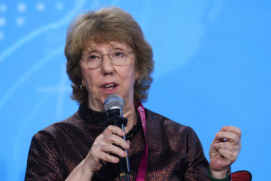 A photo of Catherine Ashton speaking into a microphone.