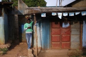 Man in Kenya reading his phone