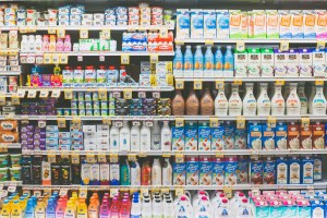A shelf of milk and alternative milks at a grocery store is pictured.