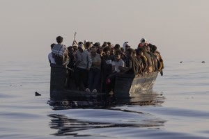 Migrants with life jackets provided by volunteers of the Ocean Viking, a migrant search and rescue ship run by NGOs SOS Mediterranee and the International Federation of Red Cross.