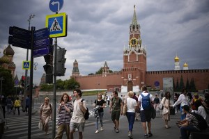 Russians walk past the Red Square