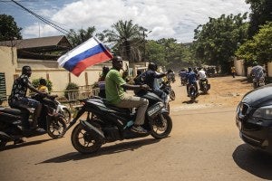 Supporters of Capt. Ibrahim Traore parade wave a Russian flag in the streets of Ouagadougou