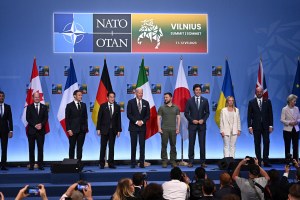 Biden stands on a stage with fellow NATO leaders