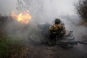 Ukrainian National guard soldiers fire at Russian positions from an anti-aircraft gun 