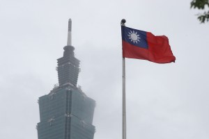 A Taiwan national flag flutters near the Taipei 101 building 