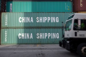 a jockey truck passes a stack of 40-foot China Shipping containers at the Port of Savannah 