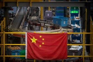 a Chinese flag hangs near an automated parcel handling line at a warehouse for an online retailer in Beijing