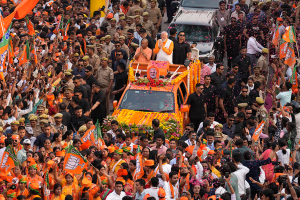 Indian Prime Minister Narendra Modi stands in a vehicle during a roadshow in Varanasi, India, on May 13, 2024