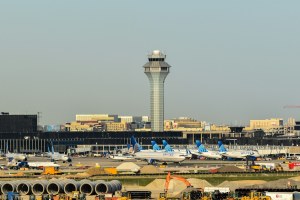 An exterior view of O'Hare airport with airplanes lined up along the runway