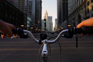 Tall buildings in Chicago behind bike handlebars