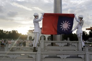 Two soldiers fold the Taiwanese national flag