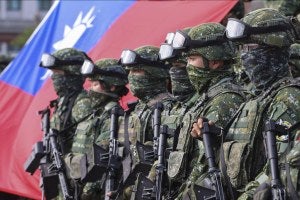 Soldiers pose for group photos with a Taiwanese flag